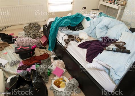 Showing Mess In A Teenage Girls Bedroom Including Food Clothes And Bags