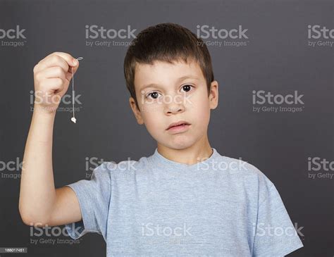 Sad Boy Show Lost Tooth On A Thread Stock Photo Download Image Now