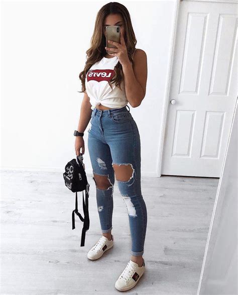 black girl outfit with ripped jeans crop top and white sneakers