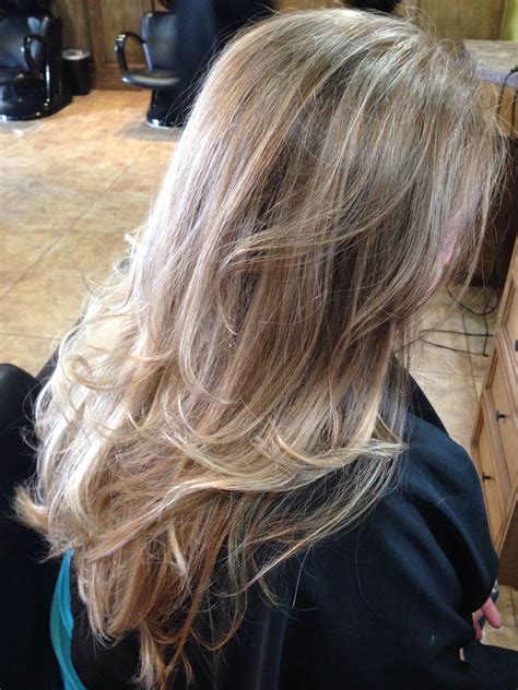 sandy blonde base with fine platinum highlights a few dark blonde accent lowlights and balayage