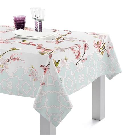 A White Table With Pink Flowers On It And Two Glasses Sitting On Top Of