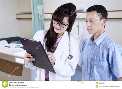 Doctor Explaining Examination Report To Her Patient Stock Photo Image