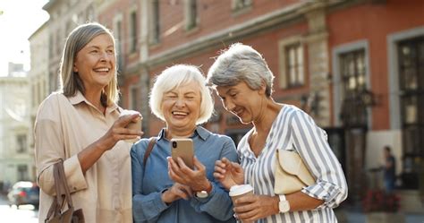 Premium Photo Happy Joyful Seniors Smiling While Watching Pictures On