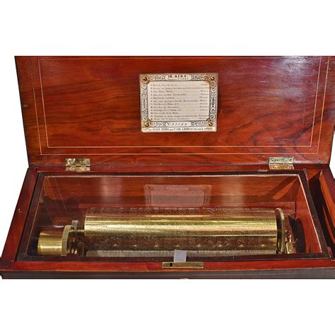 Here is a fine mermod swiss cylinder music box which works off of a nickel coin and plays 12 tunes. Swiss Nicole Frères Early Key Wind 12" Fat Cylinder Music Box - Renaissance Antiques