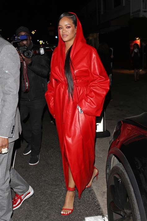 Rihanna Covers Her Baby Bump Under A Red Trench Coat While Stepping Out