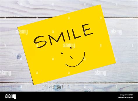 Word Smile And Smiley Face On Wooden Table Stock Photo Alamy