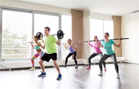 Happy People Exercising With Barbell Bars In Gym Stock Image Image Of