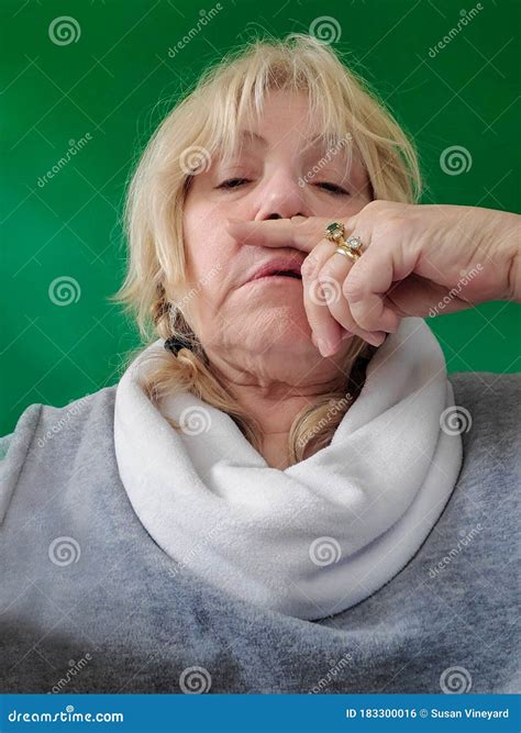 Senior Woman With Finger Under Nose Runny Nose Or Sneeze Touching Face Sick Green Screen