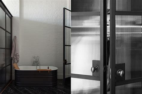 the old school house bathroom with rolled steel screens with fluted glass reeded glass room