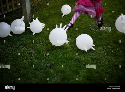 Inflated Latex Rubber Gloves Become Makeshift Balloons Kicked Around The Garden By A Four Year