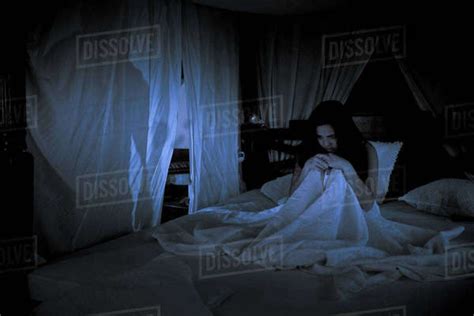 Anxious Teenage Girl Sitting In Her Bed At Night Stock Photo Dissolve