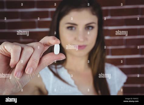 Pretty woman showing white pill Stock Photo - Alamy
