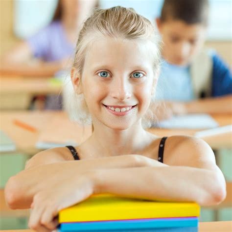 Smiling Schoolgirlportrait Of A Smiling Schoolgirl Sitting The C Stock