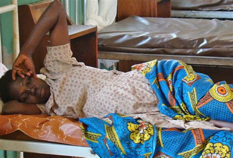 A Mother Awaits Treatment At A Health Centre In Gulu Northern Uganda