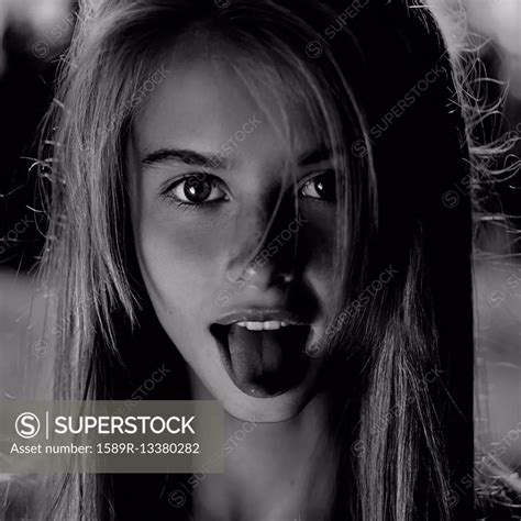 Caucasian Girl Sticking Out Her Tongue Superstock