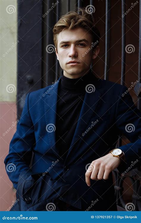 Portrait Of An Attractive Man In A Suit And A Black Sweater Close Up