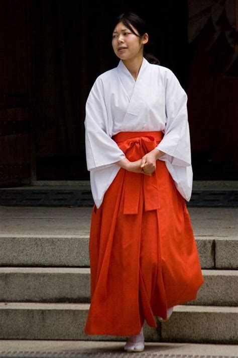 The Shrine Maiden Or Miko Wears A White Haori Kimono Jacket Tucked