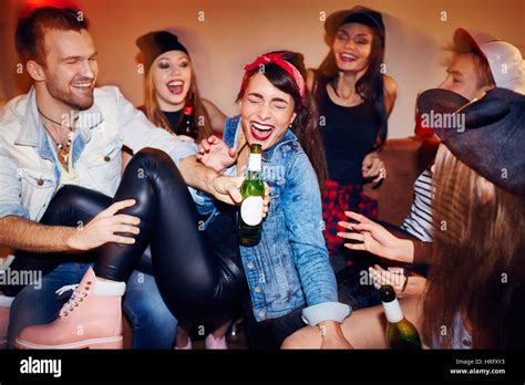 Group Of Trendy Young People Getting Drunk At Late Night Swag Party Going Crazy And Laughing