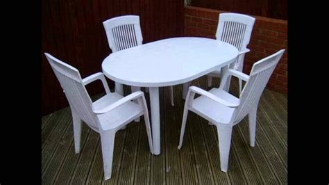 Set two stacking patio chairs beside a metal outdoor. OUTDOOR PLASTIC TABLE AND CHAIRS - YouTube