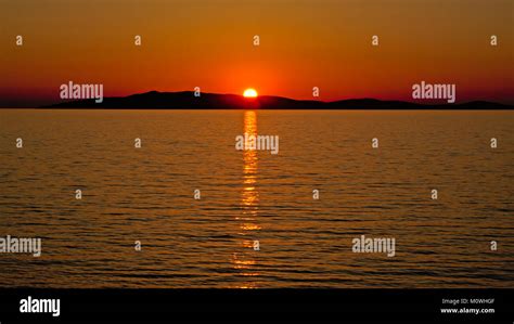 Warm Orange Sunset Over The Silhouette Of An Island In The Adriatic Sea