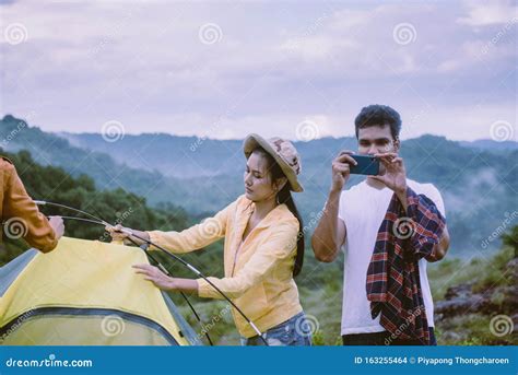Group Of Best Friends Traveller Putting Up A Tent In Natureenjoying