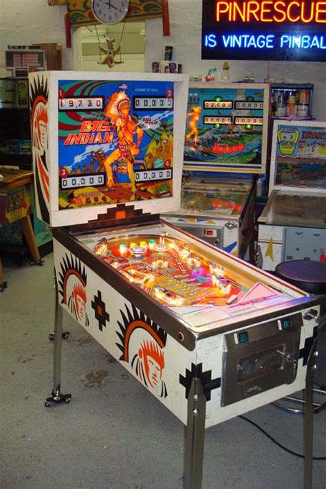 Two Pinball Machines Sitting Next To Each Other
