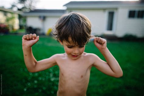 Boy Flexes His Muscles Del Colaborador De Stocksy Maria Manco Stocksy