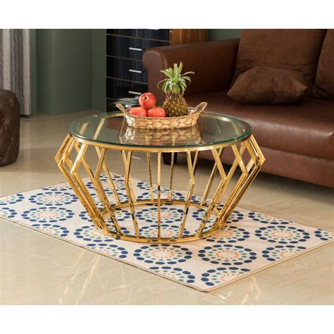 Instill contemporary elegance in your space with this small space friendly round coffee table in the living room, family room, or den. Everly Quinn Round Shaped Glass Gold Stainless Steel Metal ...