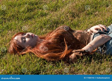 A Beautiful Redhead Sleeping In The Meadow Stock Image Image Of