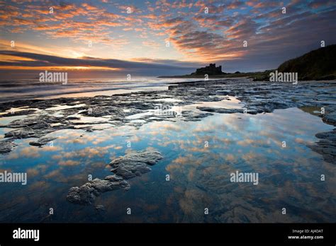 Spectacular Sunrise Over Bamburgh Castlenorthumberland Stock Photo Alamy