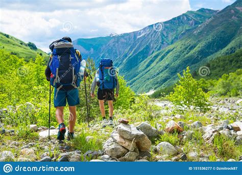 Hiking In Mountains Men Hike In Mountain Trail Tourists With