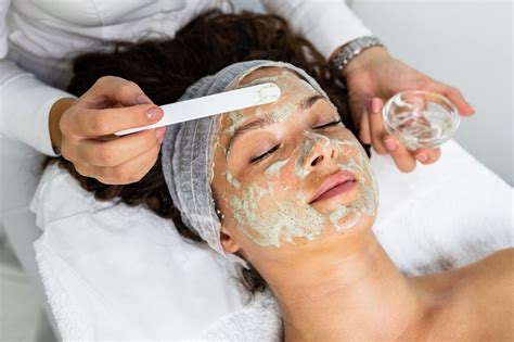 Beautiful Woman Receiving Natural Green Peel Facial Mask With Rejuvenating Effects In Spa Beauty