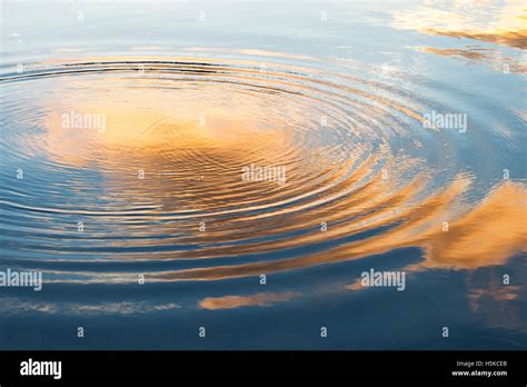Water Ripples And Cloud Reflections At Sunrise In Scotland Stock Photo