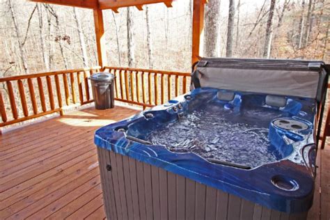 Living room with sofa, 2 chairs and fireplace. Lazy Oaks Cabin - Tranquil Hills Lodging - Cabins in ...