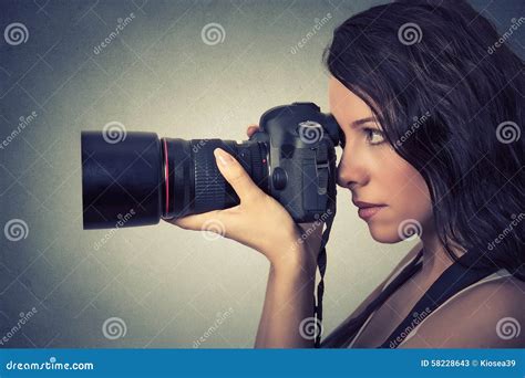 Young Woman Taking Pictures With Professional Camera Stock Image