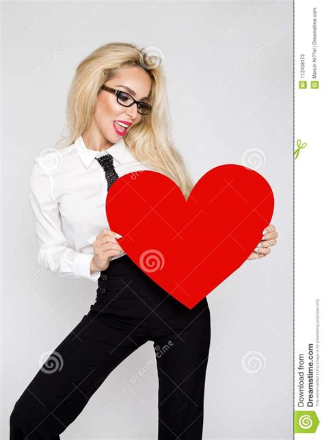 Beautiful Sexy Elegant Blonde Woman Holding A Red Valentine Heart