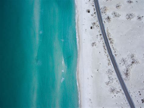 Birds Eye View Of A Road Along A Beach During Daytime Pixeor Large