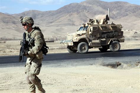 Us Army Soldiers With The 10th Mountain Division Patroling Outside Of