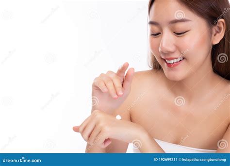 Beautiful Asian Woman Apply Body Lotion Or Sunscreen Lotion To Hand For