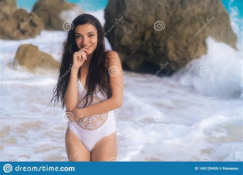 Aantrekkelijk Gelukkig Meisje In Het Witte Zwempak Stellen Op Strand Met Wit Zand En Grote