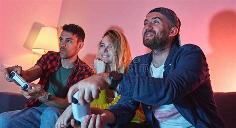 Playful Group Of Friends Are Playing Video Games Together In The Living