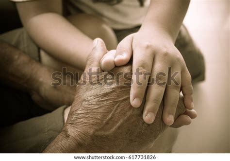 Hands Little Kids Holding Elderly Man Stock Photo Edit Now 617731826