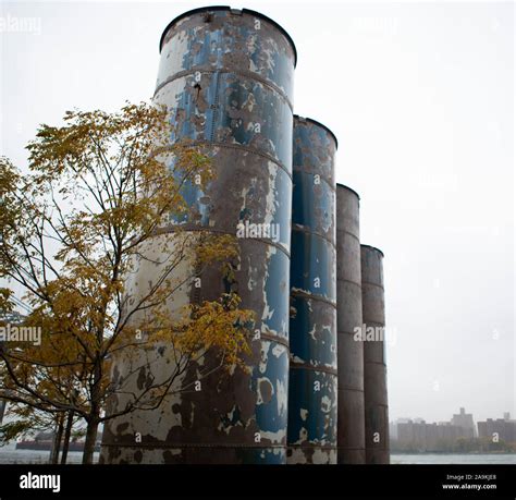 Four Industrial Chimneys With Autumn Tree Stock Photo Alamy