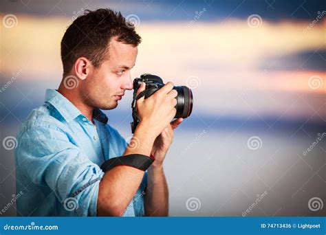 Handsome Young Photographer Using His Modern Dslr Outdoors Stock Photo