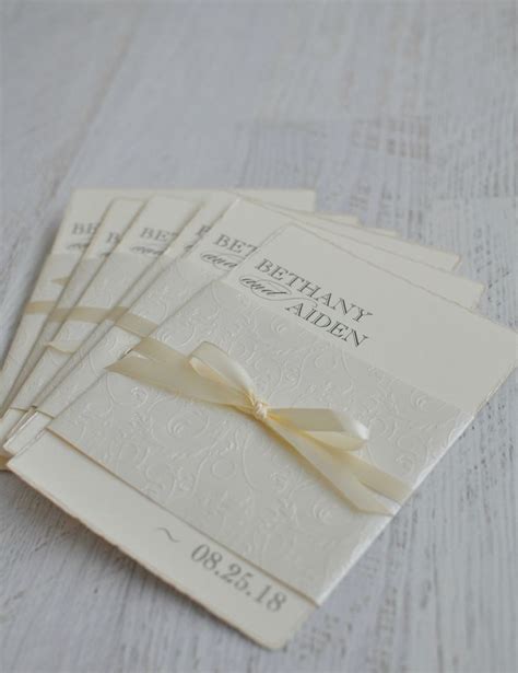 Elegant Ivory Wedding Invitation Wrapped In Textured Paper And Satin