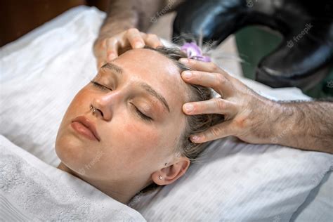 Premium Photo Professional Masseur Makes Woman Head Massage