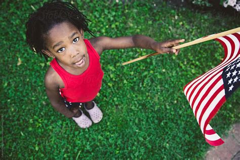 african american girl in red white and blue usa flag outfit holding a usa flag del