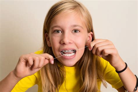 How To Floss With Braces A Guide For Kids Weiss And Tor Orthodontics