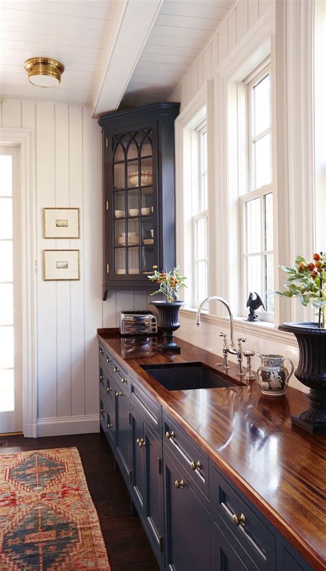 Discover inspiration for your small kitchen remodel or upgrade with ideas for storage, organization, layout and small trendy dark wood floor and brown floor kitchen photo in new york with a farmhouse sink, blue cabinets, white backsplash, stainless steel. Kitchen with Blue Cabinets (With images) | Kitchen remodel ...