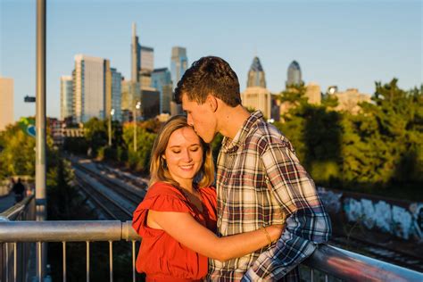 Philly Couple Kissing With The Skyline Behind Them For Their Engagement Photos Proposal